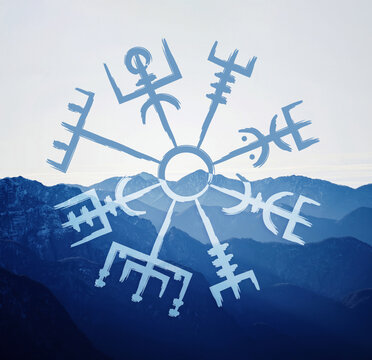 Hand drawn norse symbol of vegvisir also known as viking compass above mountains.