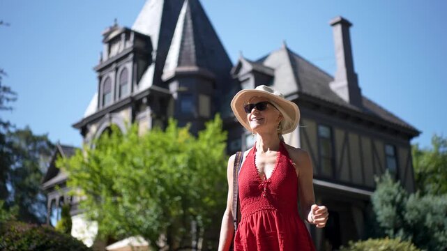 Senior woman smiles and explores winery, enjoying the lovely day and beautiful surroundings in Napa and Sonoma wine region