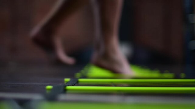 Selective focus bokeh background video, mobility ladder exercise practice, man working on movement, fitness boxing sports theme, b roll background video