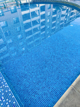 Pool reflects buildings in urban area during the day