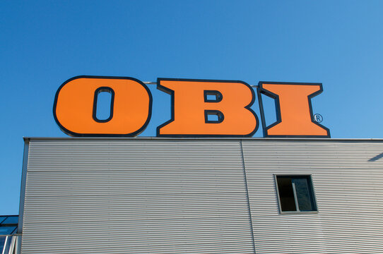 OBI orange company logo sign on hardware store roof facade in San Antonino