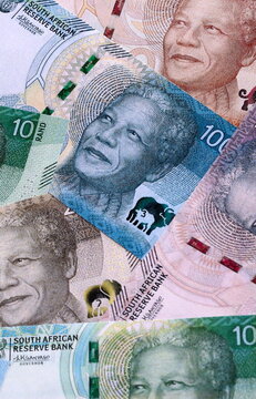 South African rand money bills pile on table. South Africa banknotes of ZAR currency close up.