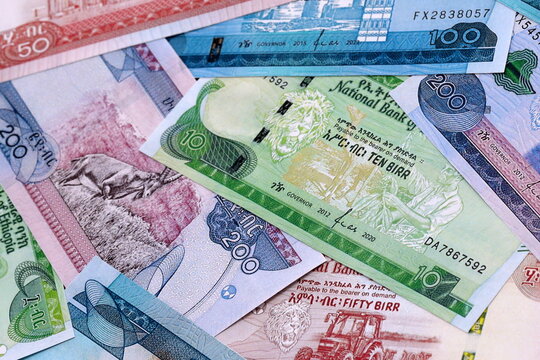 Ethiopian birr money bills pile on table. Ethiopia banknotes of ETB currency close up.