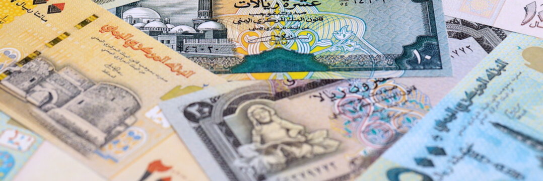 Yemeni rial money bills pile on table. Yemen banknotes of YER currency close up.
