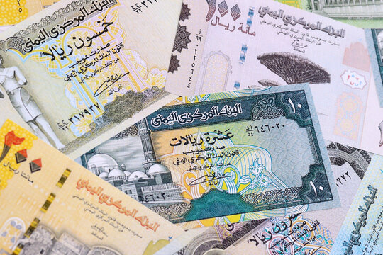 Yemeni rial money bills pile on table. Yemen banknotes of YER currency close up.