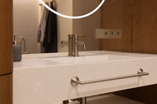 Close-up of premium modern bathroom sink and faucet with elegant mirror reflection