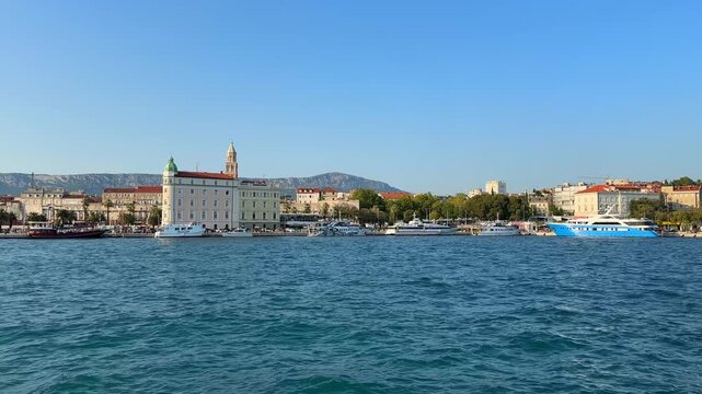 Panoramic view of the historic waterfront of Split, Croatia, with boats and ships docked along the Adriatic Sea coast
