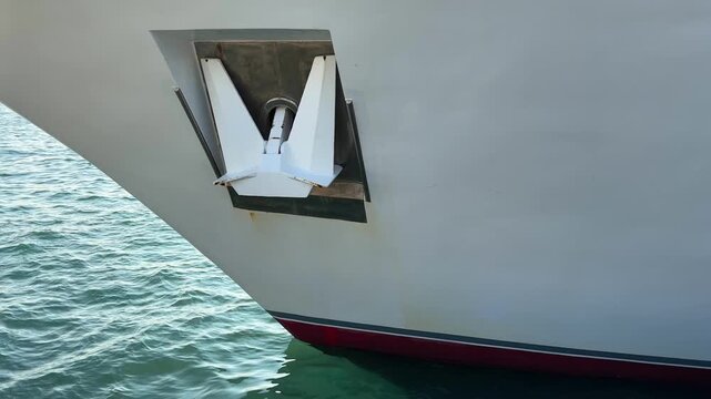 Close up of a white ship anchor on the bow of a cruise ship at sea