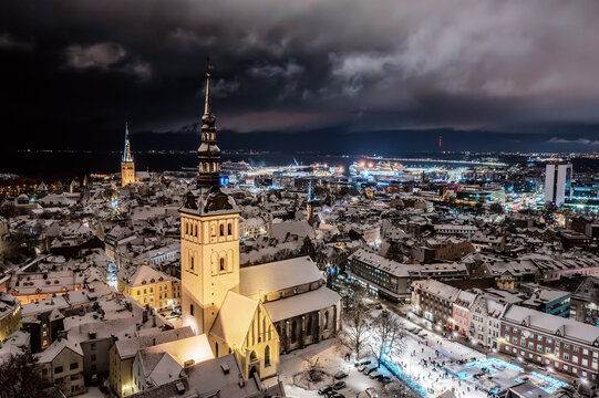 Aerial night View of Tallinn in winter, roofs are covered with snow, Christmas mood