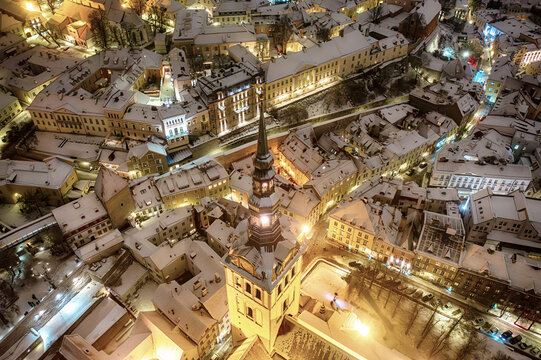 Aerial night View of Tallinn in winter, roofs are covered with snow, Christmas mood