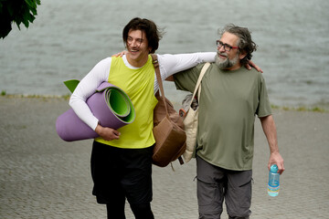 Naklejka premium Two generations walking together after outdoor workout
