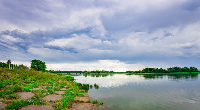Serene lake reflects a brooding sky