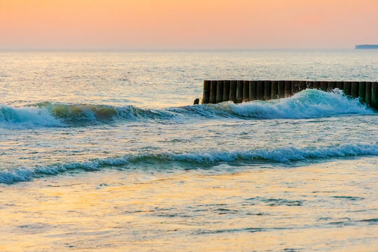 Sunset twilight over sea wooden breakwater