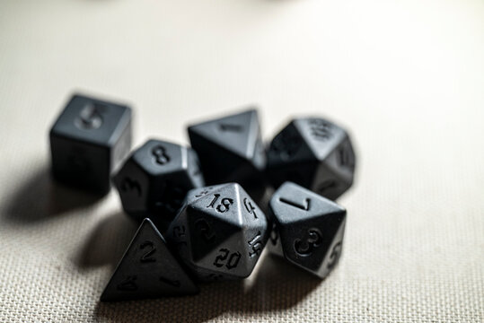 Black polyhedral RPG dice set on neutral background The Concept of tabletop gaming and chance