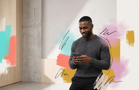 Smiling man using smartphone with abstract paint backdrop