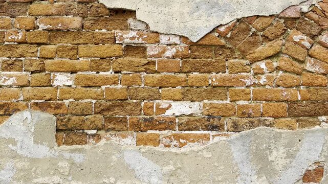 Exposed red brick on old wall creates textured background plate
