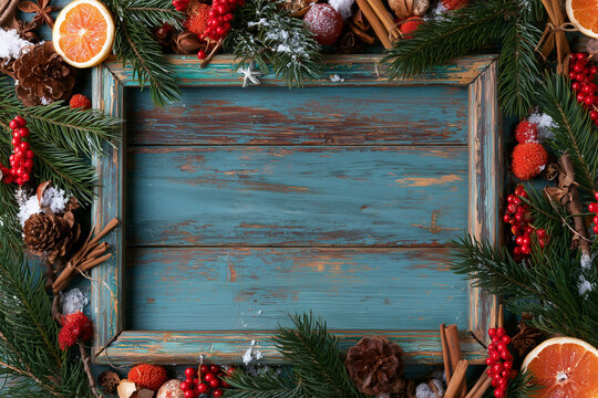 A backdrop for invitations, announcements, or posters for New Year, Christmas, winter holidays, and vacations. Wooden texture, festive decor with fir branches. Space for text.