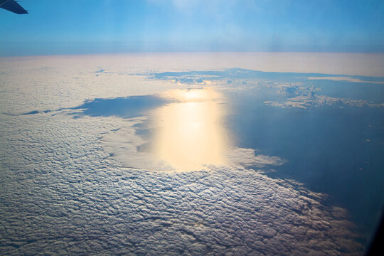 Aerial Sun Reflection On Ocean Through Clouds