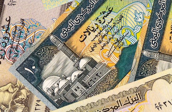 Yemeni rial money bills in pile on table. Yemen YER currency cash close up
