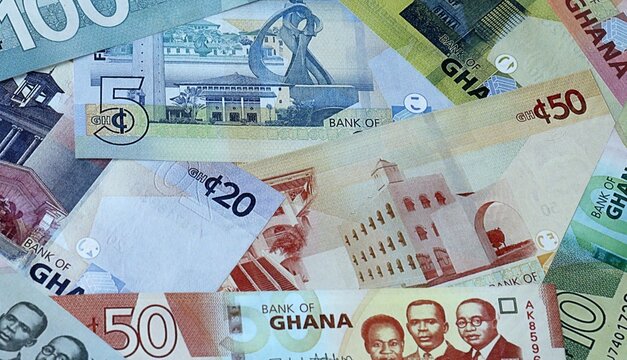 Ghanaian cedi money bills in pile. Big amount of Ghana GHS currency cash close up. Concept of casino