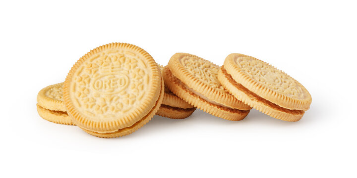 Golden oreo sandwich cookies with vanilla cream filling on a white background