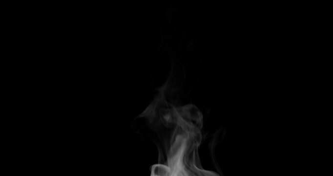 White isolated steam rises in graceful curves on a black background in slow motion. This steam trickle is perfect for overlay use with various blending modes, hot drink or food steam concepts.