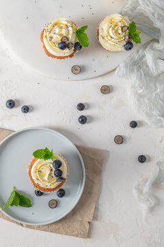 Overhead View of Vanilla Cupcakes with Blueberry and Mint Topping