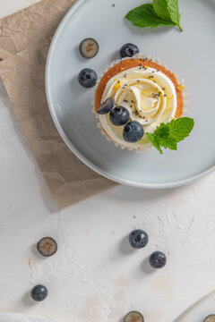 Delicious blueberry and chia seed cupcake on a light grey plate