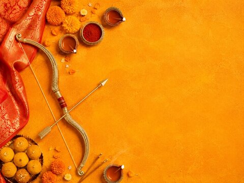 Dussehra Bow and Arrow Flat Lay with Diyas Sweets and Copy Space