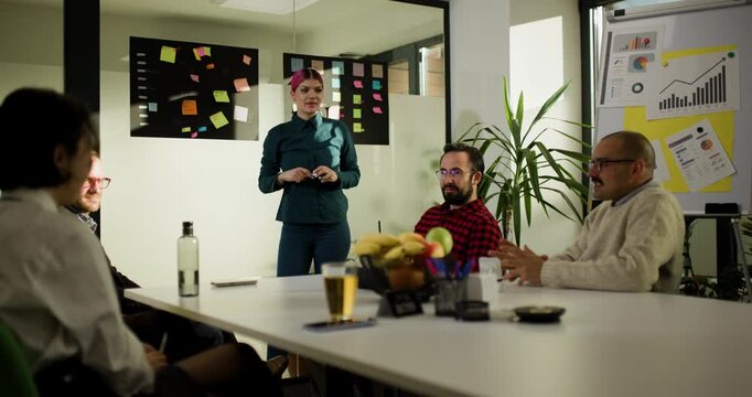 Business team meets in office to discuss plans and ideas as they interact during a presentation and share thoughts within a creative environment