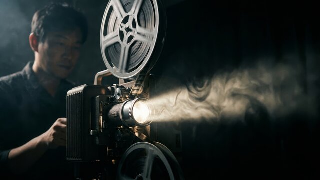 Entertainment - Asian Man Operating Vintage Movie Projector in Cinema