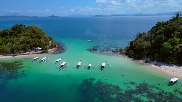 Palawan island hopping with traditional bangka boats. Dramatic aerial view drone