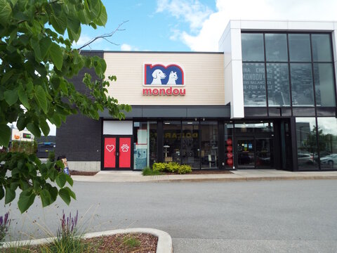 Gatineau, Quebec, Canada &ndash; June 13, 2026: A modern "mondou store exterior" features a large sign with a dog and cat graphic above glass windows on Rue de Seto.