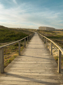 Wooden boardwalk path through dunes in Furadouro