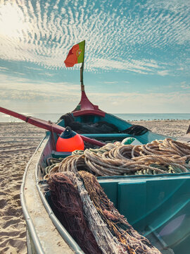 Traditional Arte Xavega fishing boat on sand beach