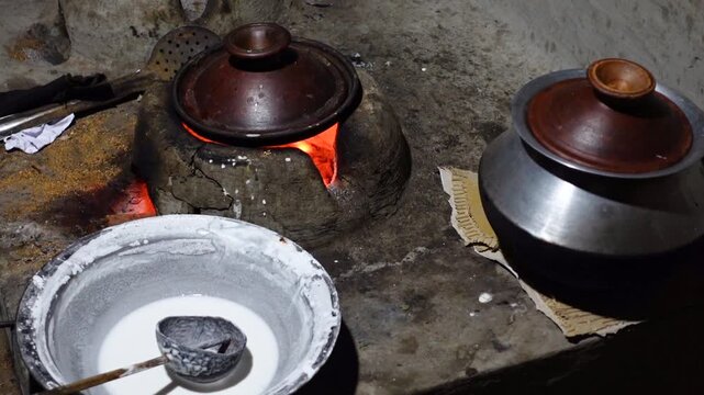 Chitai pitha is being made in a terracotta mold for making pitha in a heated clay oven. Chitai pitha is being made in a five-hole terracotta mold.