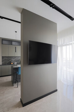 Television on partition wall in apartment