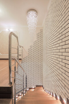 Wooden stairs interior with crystal chandelier