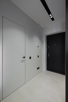 Minimalist corridor interior with hidden doors