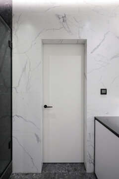 White door in bathroom interior