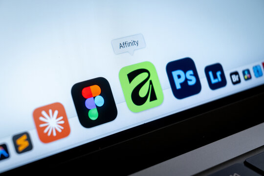 Mexico City, Mexico, 02 25 2026: A close-up horizontal view of a laptop dock featuring logos for Affinity, Figma, Adobe Photoshop, and Lightroom.