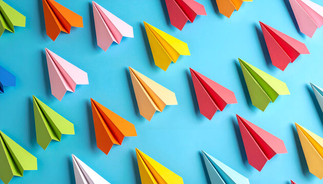 A vibrant shot showcasing a multitude of origami paper airplanes arranged in a repetitive pattern against a solid cerulean background