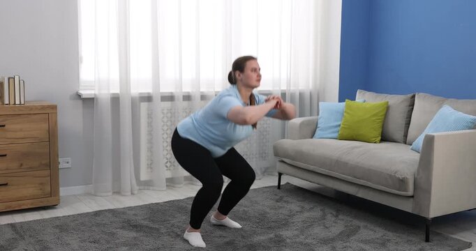 Overweight woman exercising on floor at home