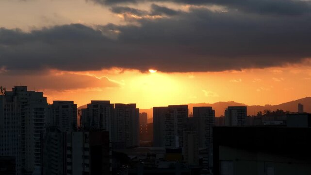 View of the sunset from a terrace between buildings in the Lapa neighborhood of Sao Paulo, Brazil.