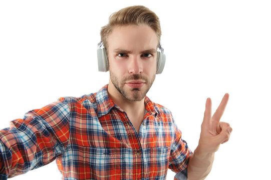 Modern millennial man lifestyle. Music style. Listen audio. Millennial man gen lifestyle. Lifestyle and music. Man listen music in audio headphones isolated on white. Making selfie with peace gesture