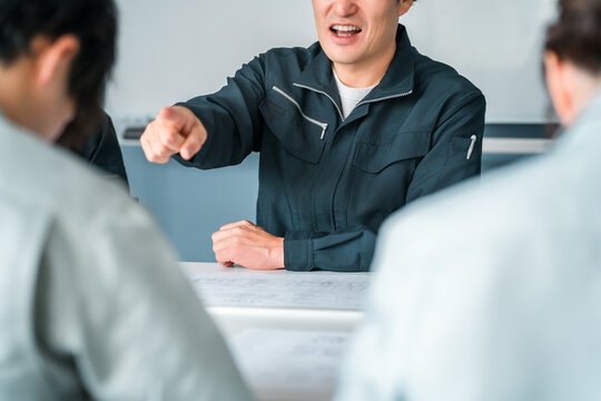A businessman in work clothes gets angry at someone during a meeting, discussion, or business negotiation (fury, scolding, lecturing).