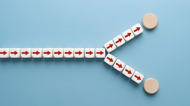 A conceptual image showing a line of wooden blocks splitting into two different directions on a blue background surface