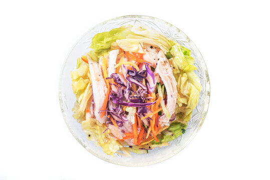 Shredded chicken salad with scallion and sald dressing in glass bowl