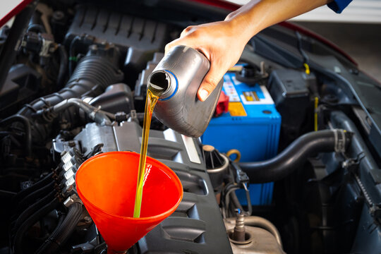 Refueling and pouring oil quality into the engine motor car Transmission and Maintenance Gear .Energy fuel concept.	
