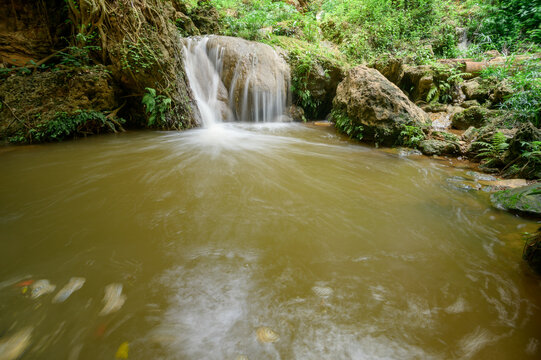 Serene Namtok Waterfall Behind Gorge in Lush Green Landscape